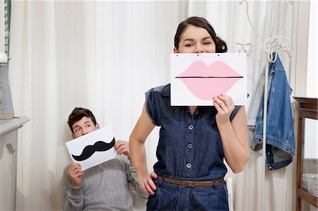 funny man looking at camera - Couple holding lips and moustache Stock Photo - Premium Royalty-Free, Code: 614-06442388