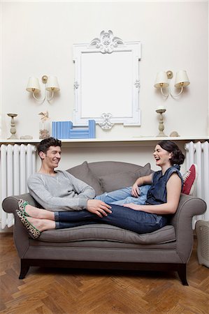 simsearch:614-06442432,k - Couple laughing on sofa Stock Photo - Premium Royalty-Free, Code: 614-06442390
