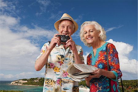 retired man in hawaiian shirt - Senior tourist couple with camera and map Stock Photo - Premium Royalty-Free, Code: 614-06442464