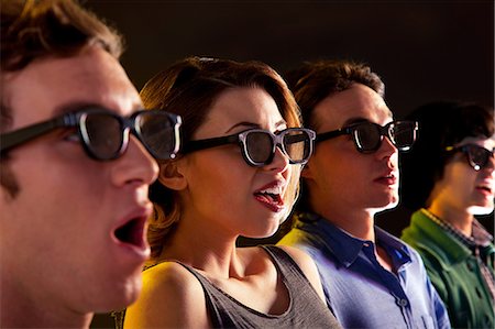 Row of people watching 3D movie Foto de stock - Sin royalties Premium, Código: 614-06442496