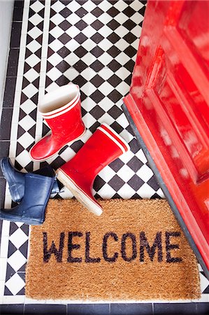 Welcome mat and wellington boots Stock Photo - Premium Royalty-Free, Code: 614-06442516