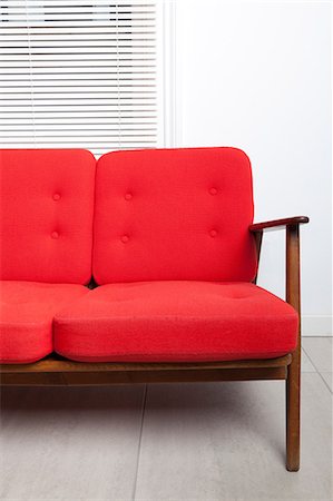 red cushion on a sofa - Red sofa Stock Photo - Premium Royalty-Free, Code: 614-06442520