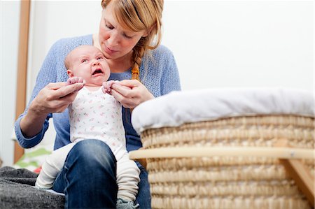 sad daughter to mom - Mother holding upset newborn daughter Stock Photo - Premium Royalty-Free, Code: 614-06442541