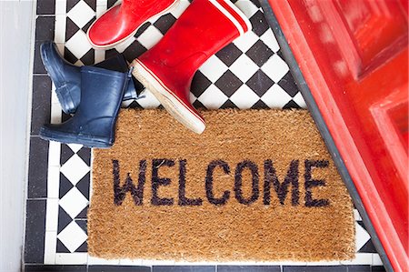 floor tiles entrance hall - Welcome mat and wellington boots Stock Photo - Premium Royalty-Free, Code: 614-06442542
