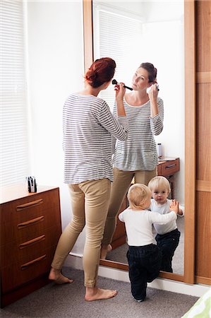 family adult children busy - Woman applying make up with son at mirror Stock Photo - Premium Royalty-Free, Code: 614-06442576