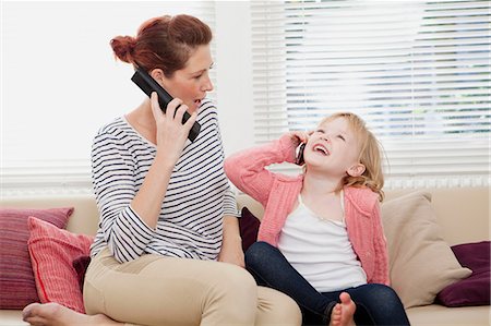 phone white woman at home - Mother and daughter on cell phones Stock Photo - Premium Royalty-Free, Code: 614-06442586