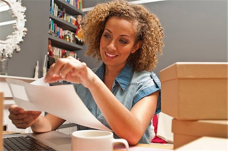 e commerce laptop - Woman sticking labels on cardboard boxes Stock Photo - Premium Royalty-Free, Code: 614-06442630