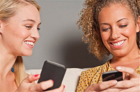 Friends holding cell phones Stock Photo - Premium Royalty-Free, Code: 614-06442633