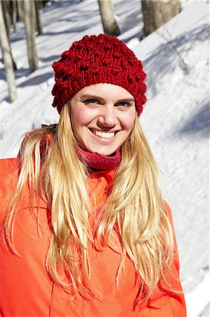 Portrait of woman wearing red knit hat and coat Stock Photo - Premium Royalty-Free, Code: 614-06442696