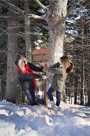 power couple - Couple fighting over wooden sign in forest Stock Photo - Premium Royalty-Free, Code: 614-06442702