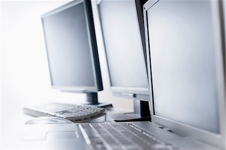 Computer screens and laptop on desk Stock Photo - Premium Royalty-Free, Code: 614-06442716