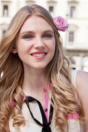 Young woman with pink rose in her hair Stock Photo - Premium Royalty-Free, Code: 614-06442734
