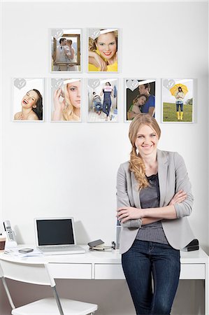 desk with wall - Confident young woman in magazine office Stock Photo - Premium Royalty-Free, Code: 614-06442777