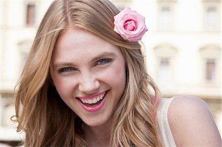 face with rose - Young woman with pink rose in her hair Stock Photo - Premium Royalty-Free, Code: 614-06442773