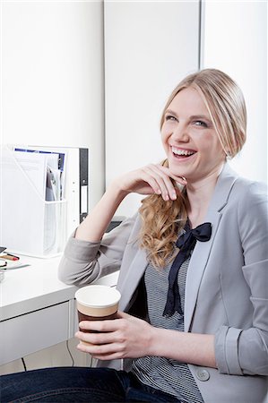 simsearch:614-06442777,k - Happy young woman in office with coffee Stock Photo - Premium Royalty-Free, Code: 614-06442783
