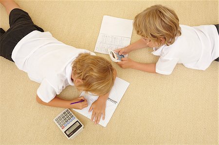 Two schoolboys doing homework Fotografie stock - Premium Royalty-Free, Codice: 614-06442827