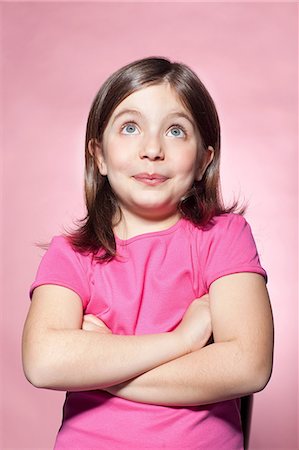 studio shot - Girl looking up with crossed arms Stock Photo - Premium Royalty-Free, Code: 614-06442892