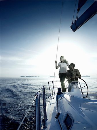 rich people outdoor - Couple steering a yacht Stock Photo - Premium Royalty-Free, Code: 614-06442933