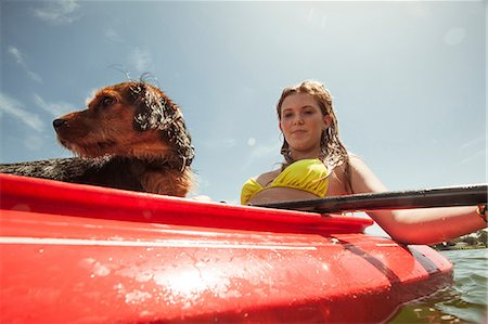Teenage girl and pet dog in kayak Stock Photo - Premium Royalty-Free, Code: 614-06442960