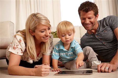 parent and toddler - Father, mother and son using digital tablet Stock Photo - Premium Royalty-Free, Code: 614-06443008