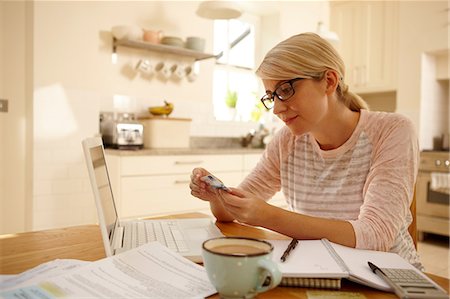 e-commerce - Woman with laptop holding credit card Stock Photo - Premium Royalty-Free, Code: 614-06443019