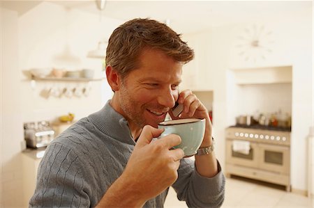 Man on phone drinking coffee Stock Photo - Premium Royalty-Free, Code: 614-06443028