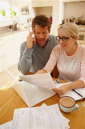 Couple doing paperwork Stock Photo - Premium Royalty-Free, Code: 614-06443021