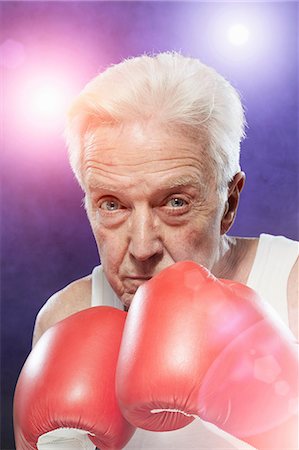 spotlight portrait - Senior man in boxing gloves Stock Photo - Premium Royalty-Free, Code: 614-06443057