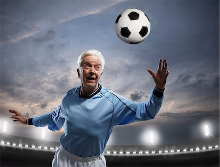 foot on head - Senior man playing football Stock Photo - Premium Royalty-Free, Code: 614-06443061