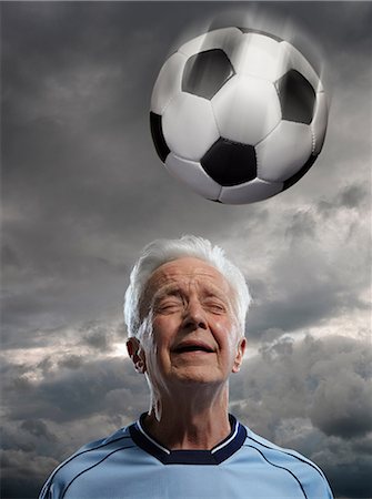 fitness and pain - Senior man heading football Stock Photo - Premium Royalty-Free, Code: 614-06443062