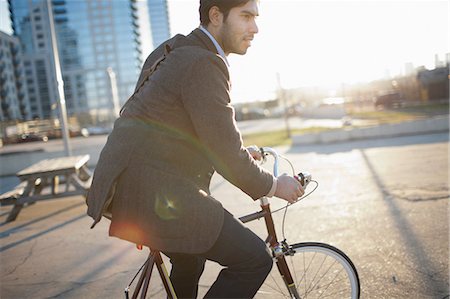 Man riding bicycle on city street Stock Photo - Premium Royalty-Free, Code: 614-06536824