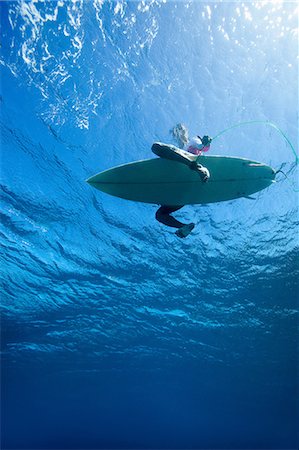 Low angle view of surfer in water Stock Photo - Premium Royalty-Free, Code: 614-06536885