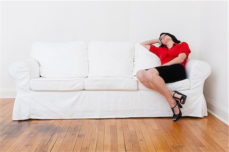 Businesswoman relaxing on sofa Stock Photo - Premium Royalty-Free, Code: 614-06536890