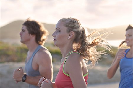 runner sun - Friends running on beach Stock Photo - Premium Royalty-Free, Code: 614-06536959