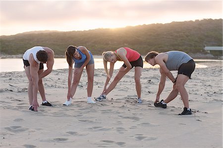 simsearch:614-06537470,k - Runners stretching on beach Photographie de stock - Premium Libres de Droits, Code: 614-06536962