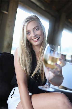 drinking sitting - Woman offering glass of wine Stock Photo - Premium Royalty-Free, Code: 614-06536975