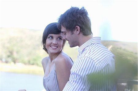romantic lake side images - Couple smiling together outdoors Stock Photo - Premium Royalty-Free, Code: 614-06536984