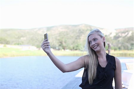 phone young white woman - Woman taking picture of herself Photographie de stock - Premium Libres de Droits, Code: 614-06536990