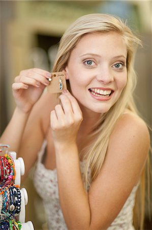 detailed jewelry - Smiling woman shopping in store Stock Photo - Premium Royalty-Free, Code: 614-06537067