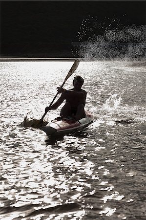 sport summer outside young caucasian adult not golf not surfing - Man rowing kayak in lake Stock Photo - Premium Royalty-Free, Code: 614-06537083
