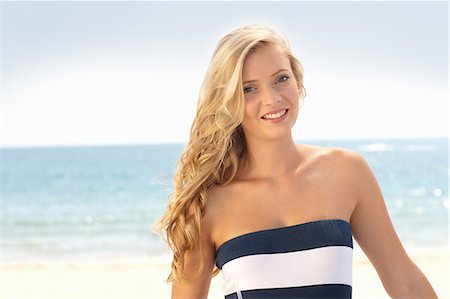 pretty 18 year old at beach - Smiling woman standing on beach Stock Photo - Premium Royalty-Free, Code: 614-06537098