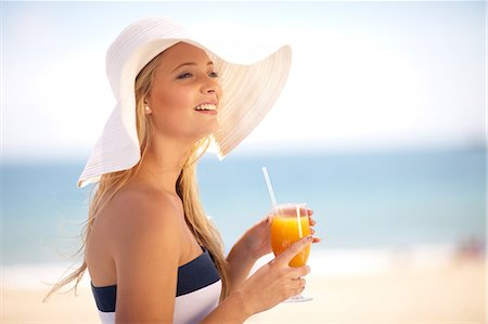 pictures of women drinking juice on a beach - Woman in floppy hat having juice Stock Photo - Premium Royalty-Free, Code: 614-06537110