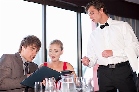 serving food at restaurant - Couple ordering food at restaurant Stock Photo - Premium Royalty-Free, Code: 614-06537196