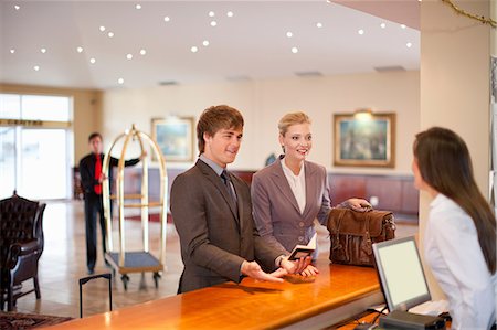 recepção - Businesswoman checking in to hotel Foto de stock - Royalty Free Premium, Número: 614-06537250