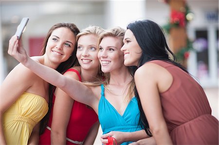 shopping and young women - Women taking picture together outdoors Stock Photo - Premium Royalty-Free, Code: 614-06537307