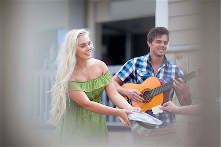 playing musical instrument - Couple playing music on street Stock Photo - Premium Royalty-Free, Code: 614-06537301