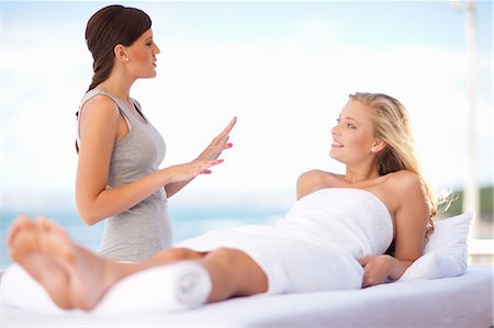 Masseuse talking to client outdoors Stock Photo - Premium Royalty-Free, Code: 614-06537332