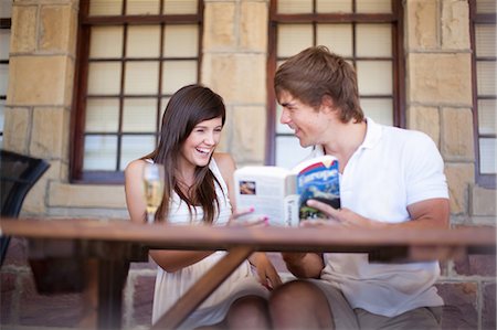 Couple reading travel book together Fotografie stock - Premium Royalty-Free, Codice: 614-06537372