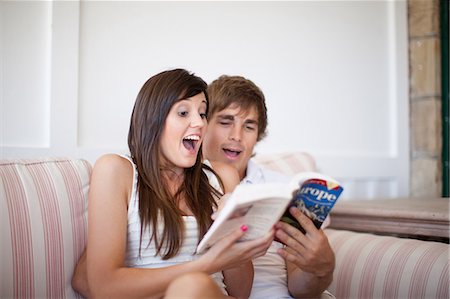 picture of expression of hug - Couple reading travel book together Stock Photo - Premium Royalty-Free, Code: 614-06537381