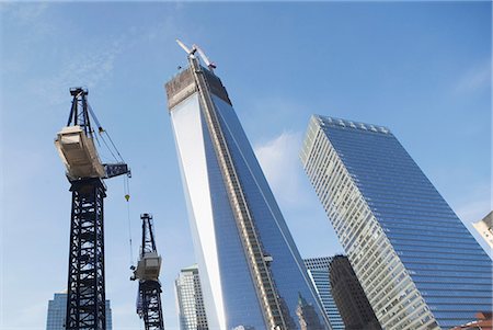 Low angle view of crane and skyscrapers Stock Photo - Premium Royalty-Free, Code: 614-06537441